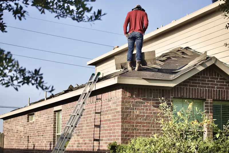 Professional roofer working on a residential roof in Sedge Brook Hills